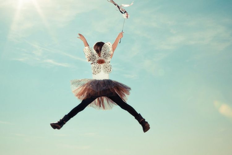 Girl jumping with a tutu and fairy wings