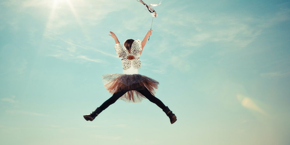 Girl jumping with a tutu and fairy wings