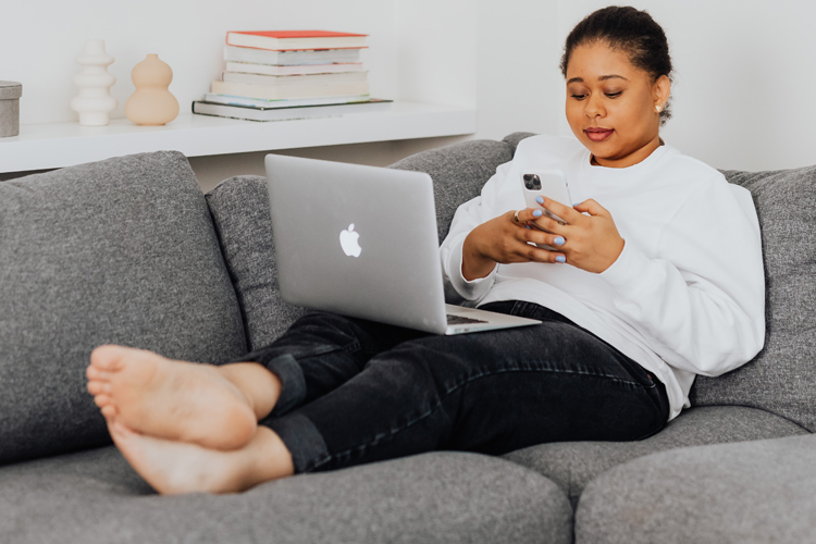 Person sitting on couch with electronic devices