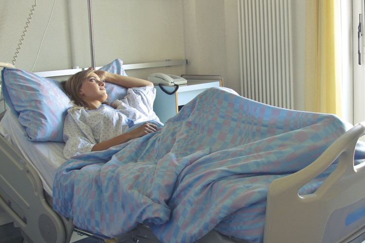 Teen laying in hospital bed