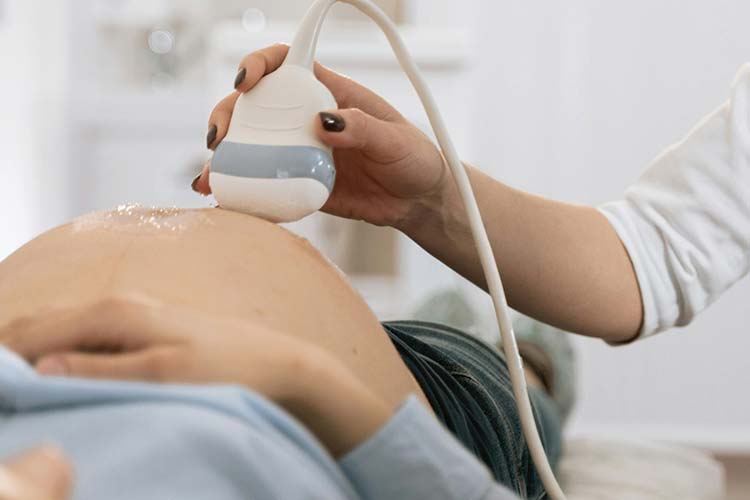 Pregnant person undergoing an ultrasound