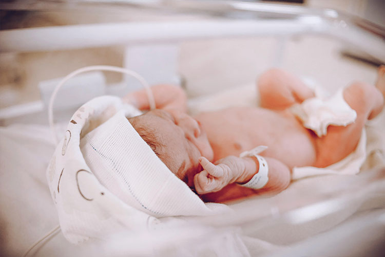 Newborn in a hospital bed